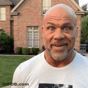 Bald Man With Beard In Front Of Brick House GIF