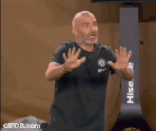 Bald Man With Beard In Front Of Hisense Machine GIF