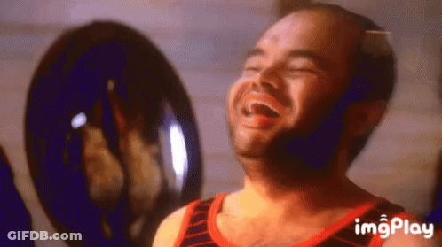 Bald Man With Beard Laughing Eyes Closed In Front Of Fan GIF