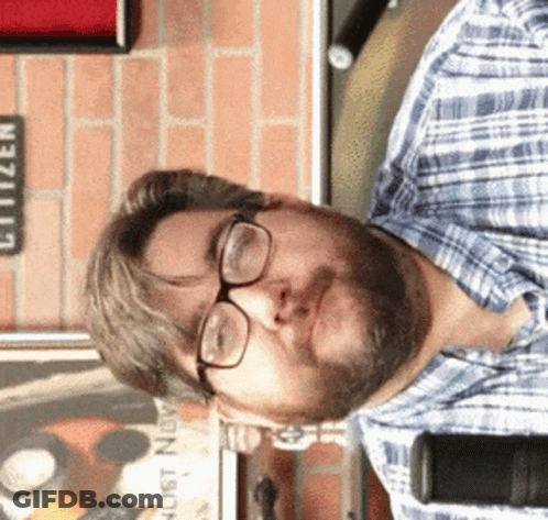 Bald Man With Beard Looking At Camera GIF