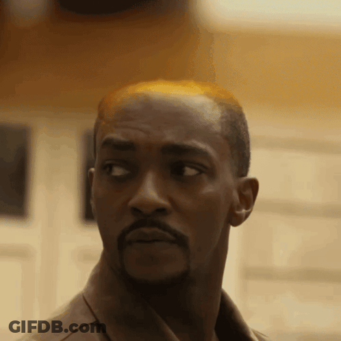 Bald Man With Beard Looking At Camera GIF