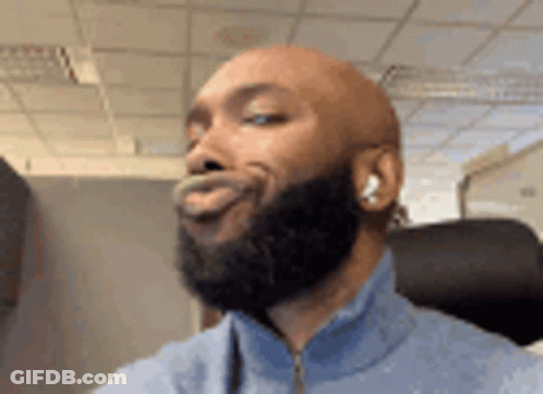 Bald Man With Beard Making Funny Face In Headphones GIF
