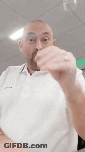 Bald Man With Beard Making Funny Face In White Shirt GIF