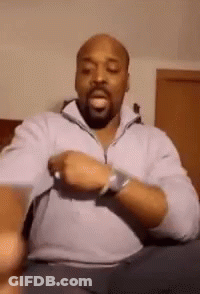 Bald Man With Beard On Couch Wearing Watch GIF