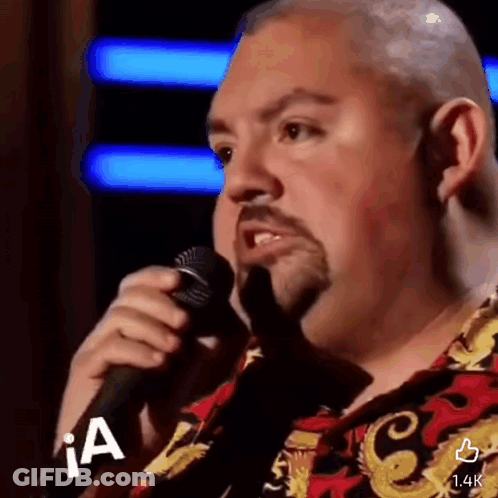 Bald Man With Beard Singing Into Microphone In Colorful Shirt GIF