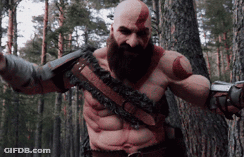 Bald Man With Beard Standing In Woods GIF