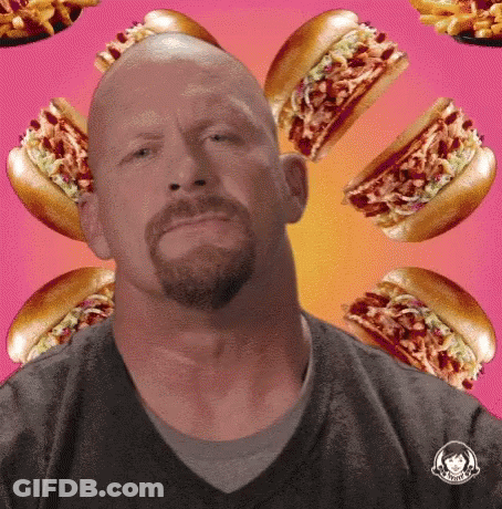 Bald Man With Beard Surrounded By Hot Dogs And Fries GIF