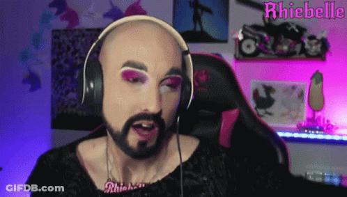 Bald Man With Beard Wearing Headphones And Rhiebelle Necklace GIF