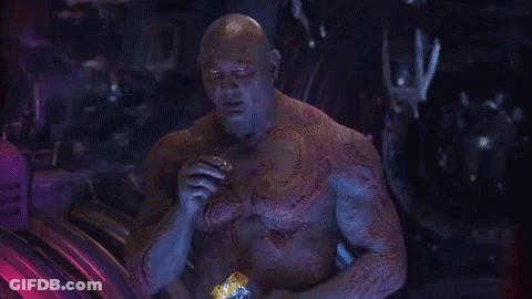 Bald Man With Chest Tattoo Sitting In Dark Room GIF