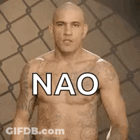 Bald Man With Chest Tattoos Standing At Fence GIF