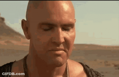 Bald Man With Eyes Closed In Desert GIF