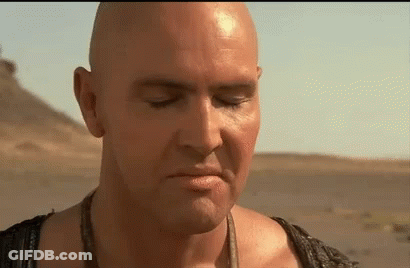 Bald Man With Eyes Closed In Desert GIF