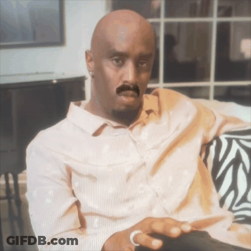 Bald Man With Fake Mustache Sitting On Zebra Couch GIF