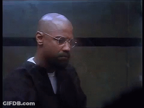 Bald Man With Glasses And Beard Standing In Front Of Wall GIF