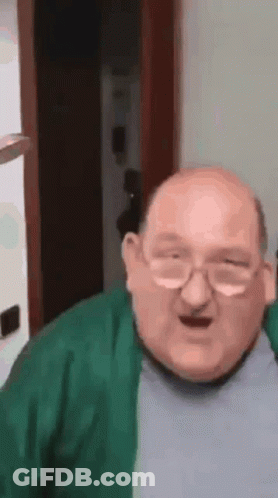 Bald Man With Glasses And Green Sweater Making Funny Face GIF