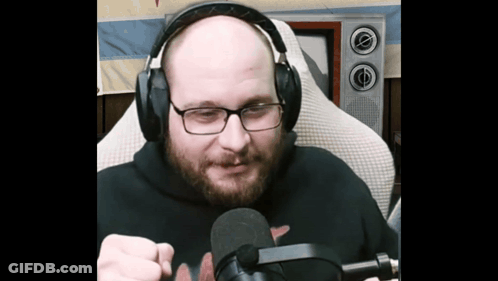 Bald Man With Glasses And Headphones Holding Microphone GIF