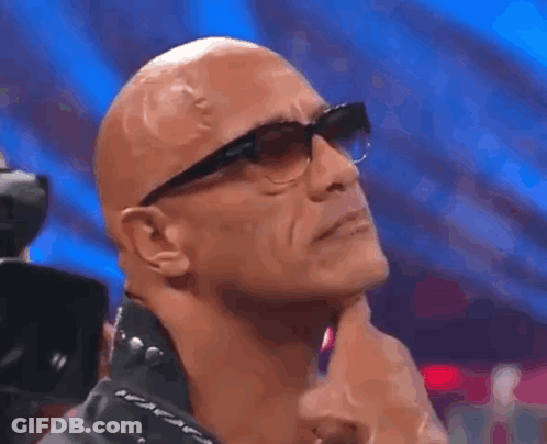 Bald Man With Glasses And Leather Jacket Hand On Chin GIF