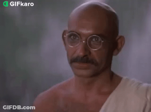 Bald Man With Glasses And Mustache In White Robe GIF