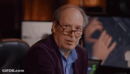 Bald Man With Glasses Sitting At Computer Desk GIF