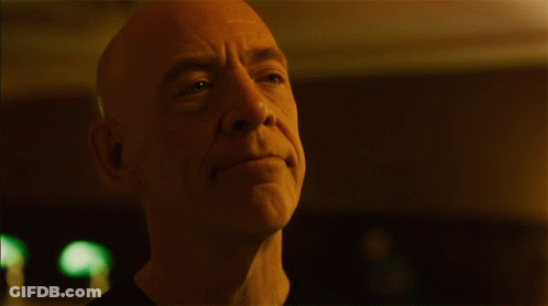 Bald Man With Green Light Behind GIF