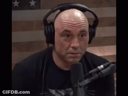 Bald Man With Headphones And Black Shirt At Microphone GIF