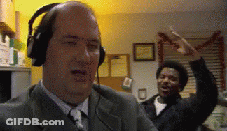 Bald Man With Headphones At Microphone GIF