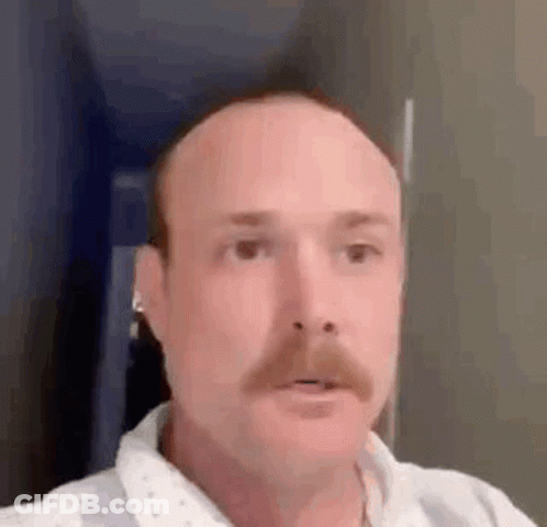 Bald Man With Mustache And Earbuds GIF