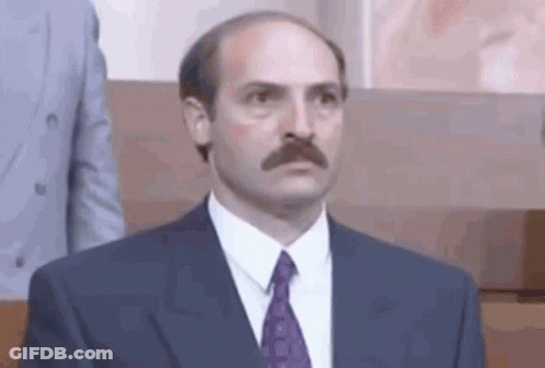 Bald Man With Mustache In Suit And Tie GIF