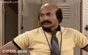 Bald Man With Mustache In Tie And Ear Muffs GIF