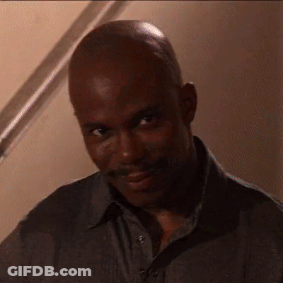 Bald Man With Mustache Looking At Camera GIF