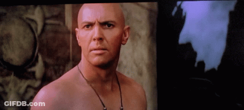 Bald Man With Necklace Looking GIF