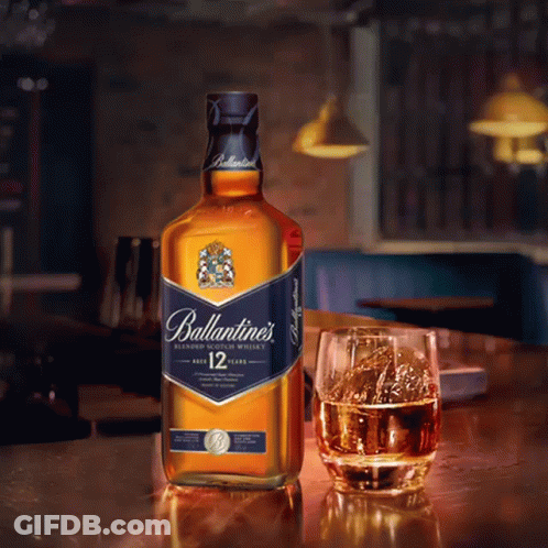 Ballantine's Blended Scotch Whisky Bottle Next To Glass GIF