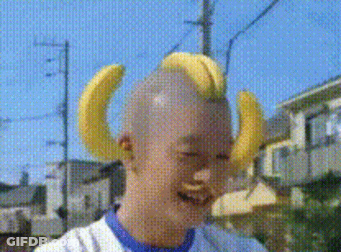 Banana Costume Mascot In Front Of Fruchaland Sign GIF