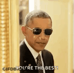 Barack Obama In Sunglasses And Suit In Front Of Picture Frame GIF