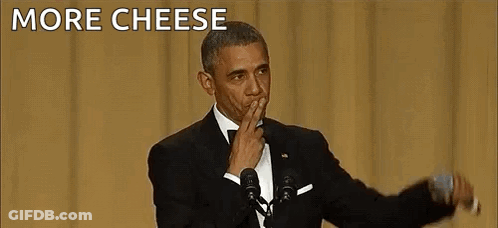 Barack Obama Is Giving A Speech In Front Of A Microphone While Covering His Mouth With His Hand . GIF