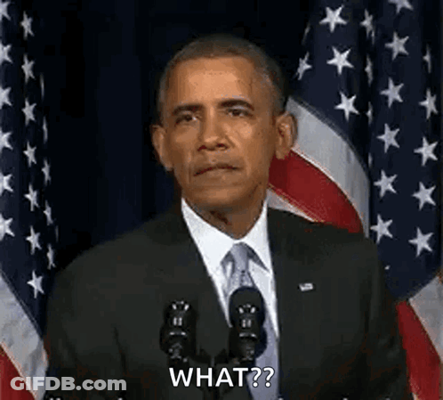 Barack Obama Is Giving A Speech In Front Of An American Flag While Standing In Front Of A Microphone . GIF