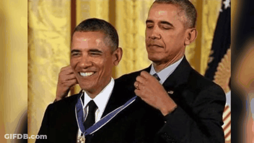 Barack Obama Is Receiving A Medal From Another Man . GIF