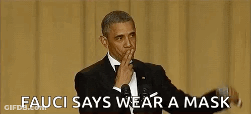 Barack Obama Is Wearing A Mask While Giving A Speech At An Event . GIF