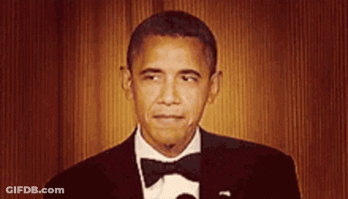 Barack Obama Is Wearing A Tuxedo And Bow Tie And Giving A Speech . GIF