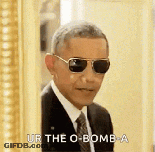 Barack Obama Is Wearing Sunglasses And A Suit And Tie And Is Standing In Front Of A Mirror . GIF
