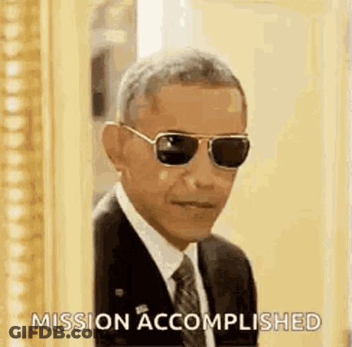 Barack Obama Is Wearing Sunglasses And A Suit And Tie While Standing In Front Of A Picture Frame . GIF