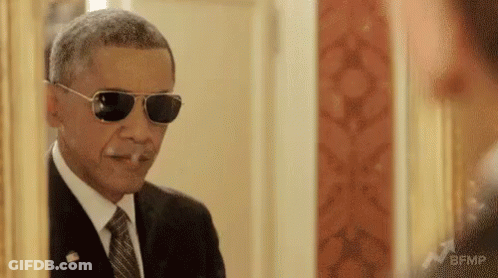 Barack Obama Is Wearing Sunglasses And Smoking A Cigarette . GIF