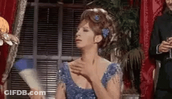 Barbra Streisand In Blue Dress Holding Fan GIF
