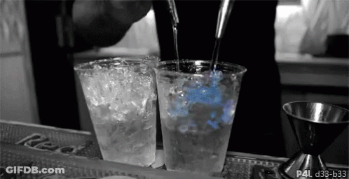 Bartender Pouring Drink Into Two Plastic Cups GIF