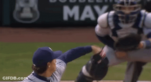 Baseball Catcher Trying To Catch Ball In Front Of Bobblehead May Sign GIF