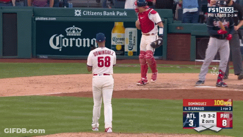 Baseball Game In Front Of Corona Ad GIF
