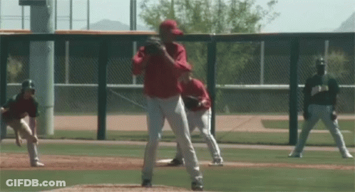 Baseball Pitcher In Red Uniform About To Throw GIF