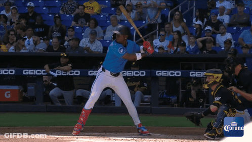 Baseball Player About To Hit Ball With Geico Banner GIF