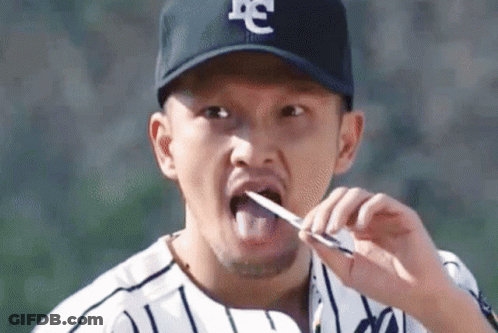 Baseball Player Brushing Teeth With Knife GIF