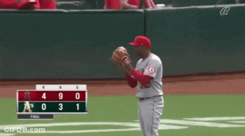 Baseball Player Catching Ball In Front Of Scoreboard A's Leading By 3 GIF
